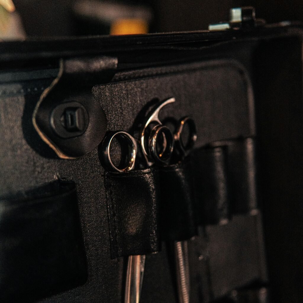 Close-up image of hairdressing scissors in a leather case, ideal for beauty industry use.